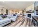Spacious open layout with fireplace, hardwood floors, views into the kitchen and a large sectional sofa at 3344 Carabiner St, Castle Rock, CO 80108