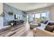 Open-concept living room boasts a modern accent wall, hardwood floors, large windows, and stylish decor at 3344 Carabiner St, Castle Rock, CO 80108