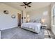 Serene main bedroom featuring plush carpet, neutral walls, ceiling fan, and ample natural light at 3344 Carabiner St, Castle Rock, CO 80108
