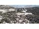 Scenic aerial view showcasing a snow-covered landscape and homes in a mountainous region at 3999 Evans Ranch Rd, Evergreen, CO 80439
