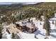 Expansive aerial view of the property and mountains, showcasing the home's integration with nature at 3999 Evans Ranch Rd, Evergreen, CO 80439