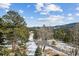Expansive backyard with a beautiful landscape with mature trees, snow, and mountain views at 3999 Evans Ranch Rd, Evergreen, CO 80439