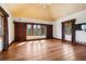Large primary bedroom with hardwood floors and large windows with scenic views at 3999 Evans Ranch Rd, Evergreen, CO 80439