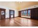 Large primary bedroom with hardwood floors and large windows with scenic views at 3999 Evans Ranch Rd, Evergreen, CO 80439