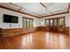 Bright bedroom with hardwood floors, log walls, and mountain views at 3999 Evans Ranch Rd, Evergreen, CO 80439