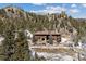 Beautiful log home nestled amidst a mountain landscape and mature trees, offering privacy and serenity at 3999 Evans Ranch Rd, Evergreen, CO 80439