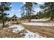 Charming property with a cozy cottage and barn, set against a serene mountain backdrop at 3999 Evans Ranch Rd, Evergreen, CO 80439
