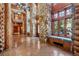Spacious foyer featuring stone pillars, a window bench, and exquisite log beam details at 3999 Evans Ranch Rd, Evergreen, CO 80439