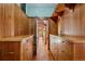 Hallway with wood paneled walls and floors with built-in storage and a view of the outdoors at 3999 Evans Ranch Rd, Evergreen, CO 80439