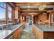 Gourmet kitchen with custom wood cabinetry, granite countertops, and professional-grade appliances at 3999 Evans Ranch Rd, Evergreen, CO 80439
