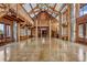 Open floor plan living room with stone columns, wooden beams, and natural light at 3999 Evans Ranch Rd, Evergreen, CO 80439