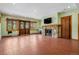 Spacious living room featuring a stone fireplace and large windows with a scenic view at 3999 Evans Ranch Rd, Evergreen, CO 80439