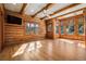 Living room featuring wood walls, wood floors, and natural light at 3999 Evans Ranch Rd, Evergreen, CO 80439