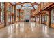 Expansive living room boasting soaring ceilings, stone fireplace, and access to the balcony at 3999 Evans Ranch Rd, Evergreen, CO 80439