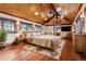 Inviting primary bedroom with wood floors, a vaulted ceiling, and natural light streaming through windows at 3999 Evans Ranch Rd, Evergreen, CO 80439