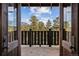 Inviting entryway with an open door view of beautiful landscape with trees and mountains at 3999 Evans Ranch Rd, Evergreen, CO 80439