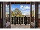 Inviting entryway with an open door view of beautiful landscape with trees and mountains at 3999 Evans Ranch Rd, Evergreen, CO 80439