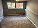 Cozy basement with carpeting and natural light, perfect for a home office or entertainment area at 3613 S Olathe St, Aurora, CO 80013