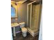 Cozy bathroom featuring a toilet, pedestal sink and a glass shower at 3613 S Olathe St, Aurora, CO 80013