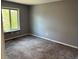 Bright bedroom with carpet and a large window providing natural light and a view of the outdoors at 3613 S Olathe St, Aurora, CO 80013