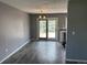 Open dining area with laminate flooring, modern lighting, and sliding door access to the deck at 3613 S Olathe St, Aurora, CO 80013
