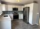 Updated kitchen featuring white cabinets, stainless steel appliances, and a stylish backsplash at 3613 S Olathe St, Aurora, CO 80013