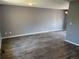 Spacious living room with grey walls, modern laminate flooring, and ample natural light at 3613 S Olathe St, Aurora, CO 80013