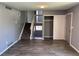 Living room featuring a staircase, closet, laminate flooring, and neutral gray walls at 3613 S Olathe St, Aurora, CO 80013