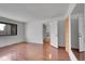 Bedroom with white walls, wood floors, large window and large closet with mirror doors at 7995 E Mississippi Ave # C1, Denver, CO 80247