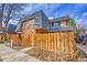 Close-up of townhome exterior with wood privacy fences, and an attractive facade at 7995 E Mississippi Ave # C1, Denver, CO 80247