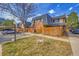 Townhome exterior featuring wood privacy fences, tidy front lawns, and assigned parking spots at 7995 E Mississippi Ave # C1, Denver, CO 80247
