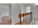 Hallway featuring wood floors, railing and closet, leading to multiple rooms at 7995 E Mississippi Ave # C1, Denver, CO 80247
