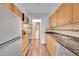 Galley kitchen featuring stainless steel appliances and wood cabinets at 7995 E Mississippi Ave # C1, Denver, CO 80247
