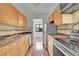 Kitchen featuring stainless steel appliances, tile backsplash and wood cabinets at 7995 E Mississippi Ave # C1, Denver, CO 80247