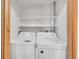 Laundry area features a stacked washer and dryer unit with shelf and door at 7995 E Mississippi Ave # C1, Denver, CO 80247