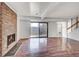 Bright living room with hardwood floors, a brick fireplace and sliding glass doors at 7995 E Mississippi Ave # C1, Denver, CO 80247
