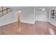 Living room featuring hardwood floors, white walls and trim, and stairs at 7995 E Mississippi Ave # C1, Denver, CO 80247