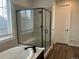 Bathroom featuring a modern glass enclosed shower and separate soaking tub at 5204 Lake Port Ave, Longmont, CO 80504