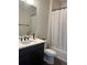 Functional bathroom features a vanity, toilet, and bathtub-shower combination with a shower curtain at 5204 Lake Port Ave, Longmont, CO 80504