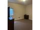 Neutral bedroom featuring plush carpet, dark dresser, and a bright window at 5204 Lake Port Ave, Longmont, CO 80504
