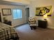 Cozy bedroom features a Colorado Buffaloes theme and comfortable seating by the window at 5204 Lake Port Ave, Longmont, CO 80504