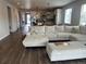 Bright, open-concept living room with a large sectional couch flows into the modern kitchen at 5204 Lake Port Ave, Longmont, CO 80504
