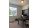 Well-lit office space features a desk, shelving, and natural light from a large window at 5204 Lake Port Ave, Longmont, CO 80504