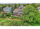 Aerial view of home showcasing a large backyard, deck, and mature trees at 9229 Sugarstone Cir, Highlands Ranch, CO 80130