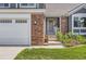 A close up shows the front door and steps leading into the house at 9229 Sugarstone Cir, Highlands Ranch, CO 80130