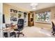 Comfortable home office with custom built-ins, and a large window at 9229 Sugarstone Cir, Highlands Ranch, CO 80130