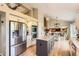 Bright open kitchen featuring stainless steel appliances, granite countertops, and modern fixtures at 9229 Sugarstone Cir, Highlands Ranch, CO 80130