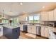 Modern kitchen with stainless steel appliances, gray cabinets, hardwood floors, and granite countertops at 9229 Sugarstone Cir, Highlands Ranch, CO 80130