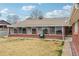 Home exterior with a sun room, brick facade, and grassy backyard at 3540 E 90Th Pl, Thornton, CO 80229