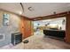 Basement area with stone wall, comfortable seating area, small refrigerator, and wall decor at 3540 E 90Th Pl, Thornton, CO 80229